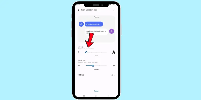 How to adjust font size on an Android phone, showing the font size slider in the display settings with an arrow pointing to it